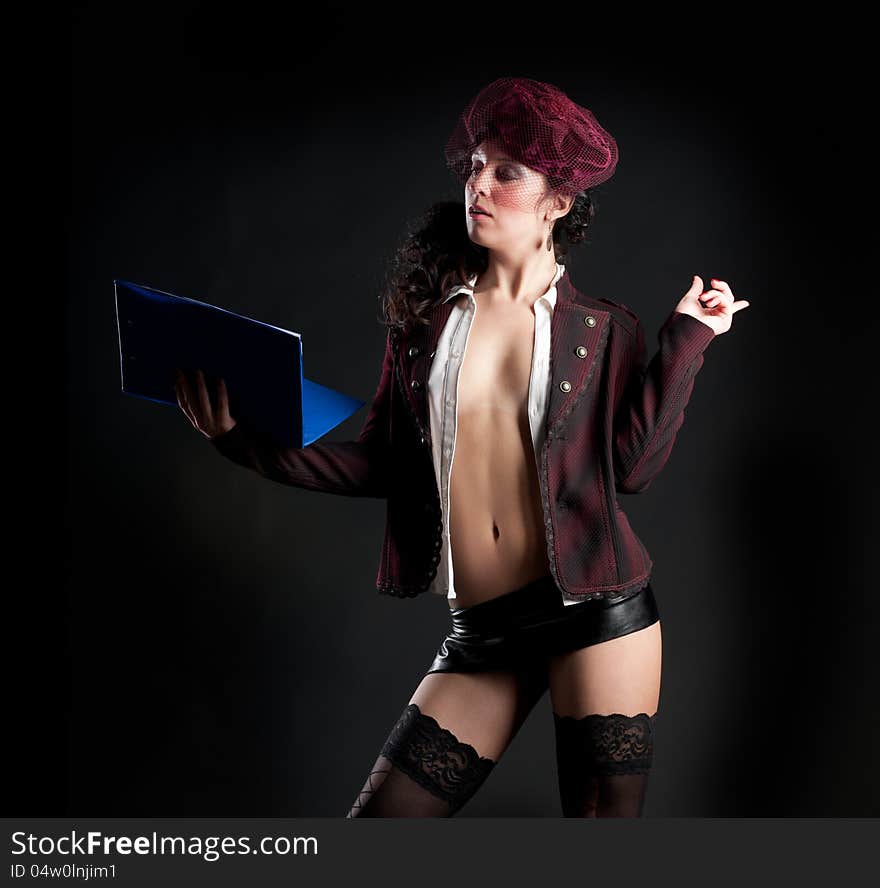 Portrait of sexy woman in erotic clothes showing perfect body on a dark background in the studio. Portrait of sexy woman in erotic clothes showing perfect body on a dark background in the studio