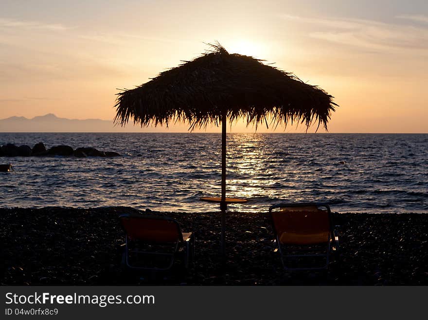 One pair of sunchairs at sunset