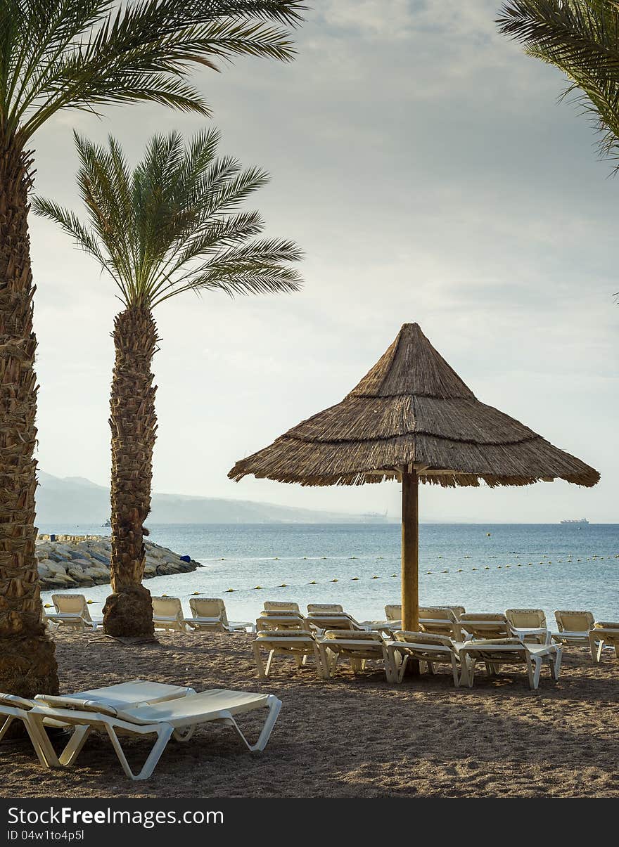 Sunshade, beds and pier in Eilat, Israel