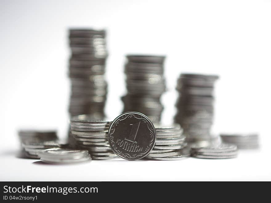 A kopek and a stack of coins on the background