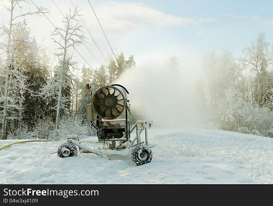 Tool is making white snow on the skiing hill. Tool is making white snow on the skiing hill.