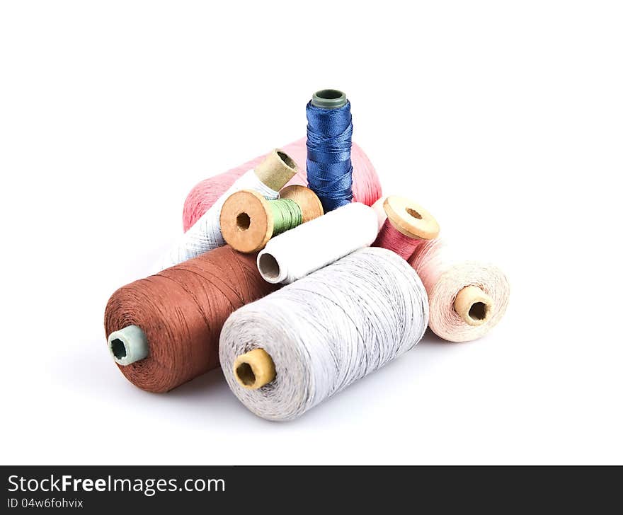 Several cones of thread of different colors on a white background. Several cones of thread of different colors on a white background