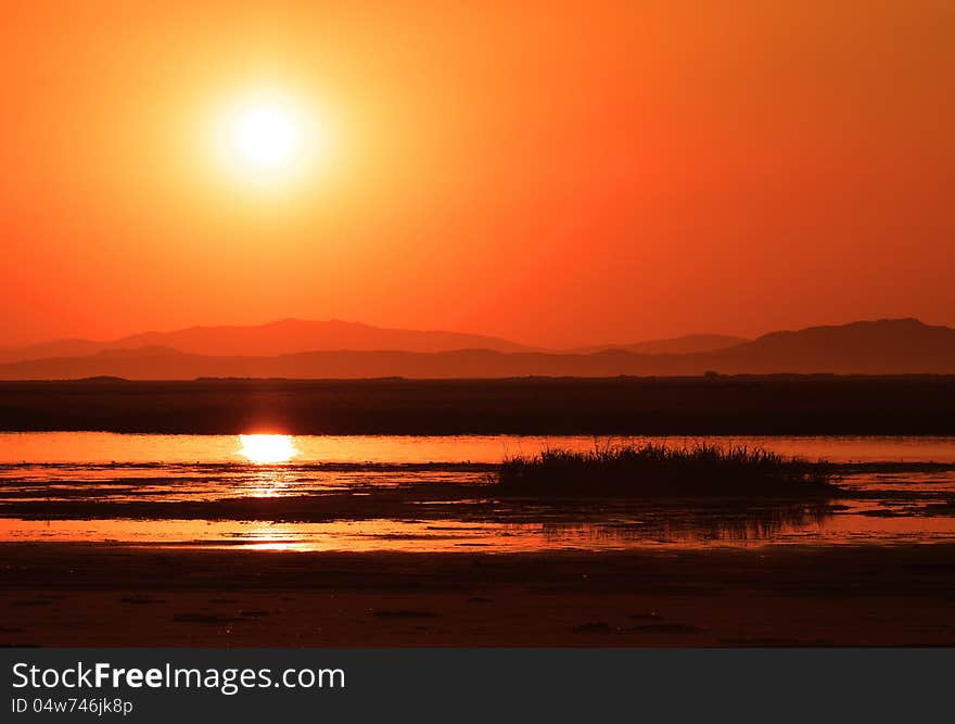 Sunset over marsh, beautiful landscape, golden river