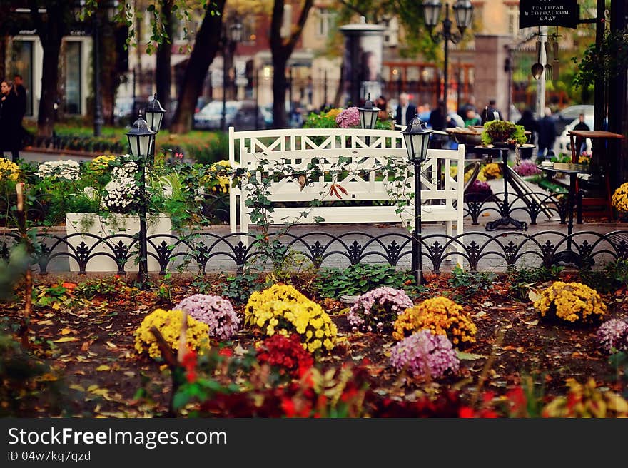 Autumn view of the yard with flower beds and with beautiful lanterns. Autumn view of the yard with flower beds and with beautiful lanterns