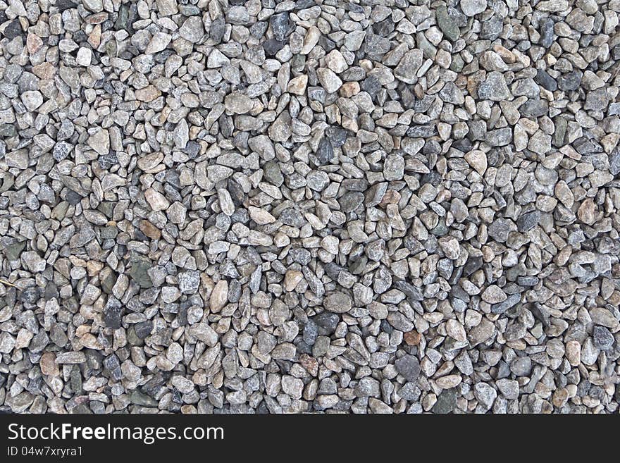 Textured background of pale crushed stone