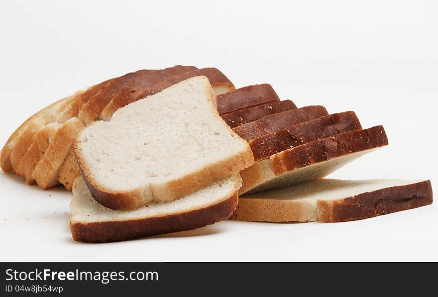 The cut loaf of white loaf for toasters on a white background. The cut loaf of white loaf for toasters on a white background