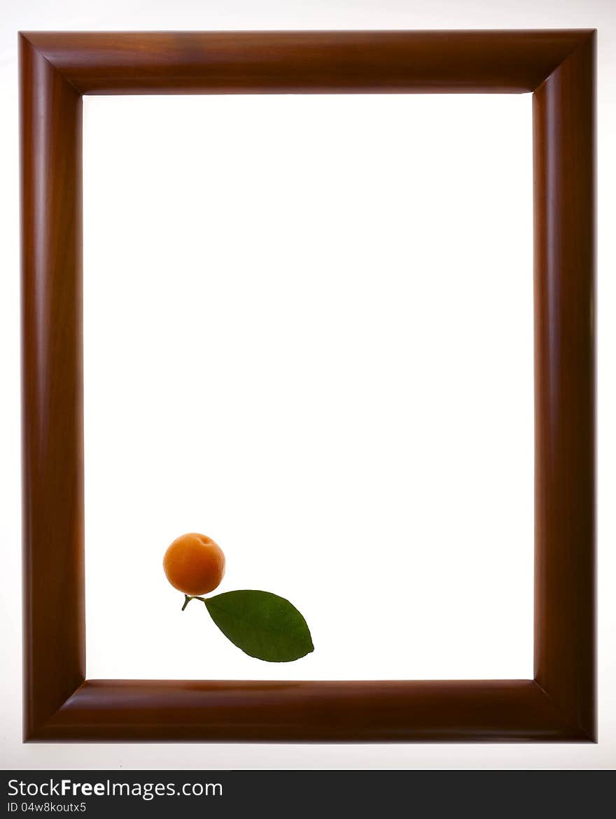 Mandarin with green leaf in the frame.