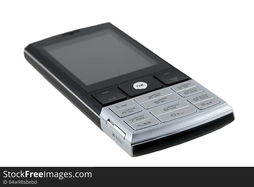 The black cellular telephone is photographed close-up on a white background. The black cellular telephone is photographed close-up on a white background