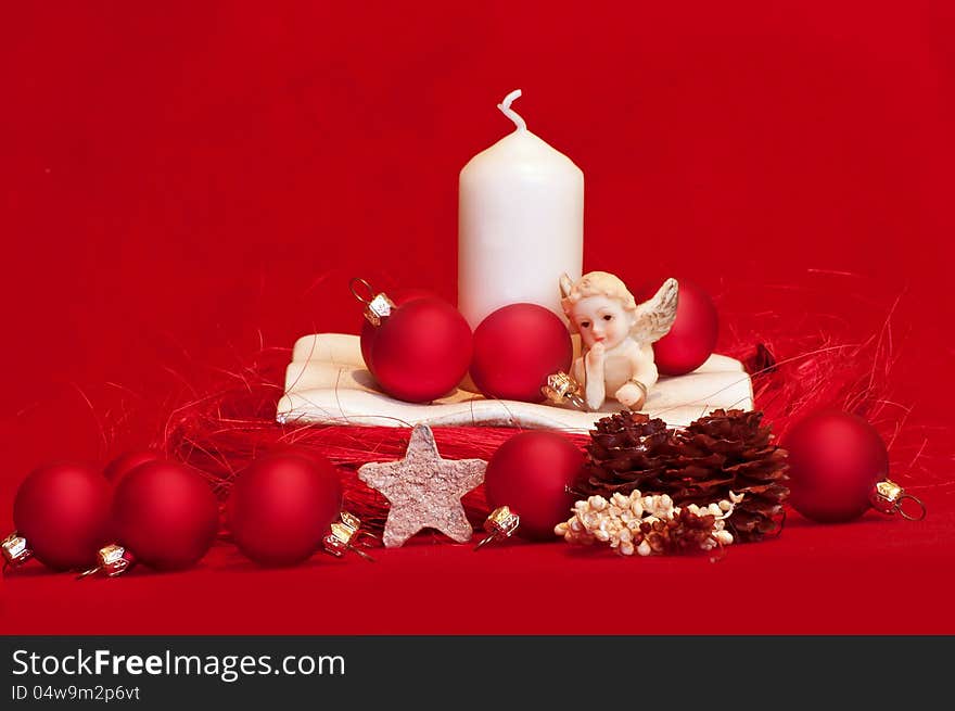 White candle and red christmas balls on red background. White candle and red christmas balls on red background