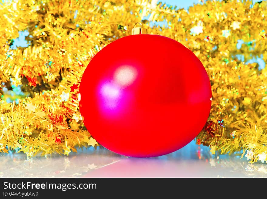 Red Christmas ball in a golden tinsel