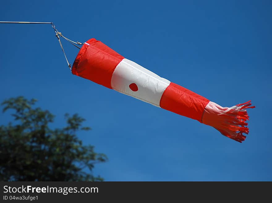 Wind indicator at the airport with blue sky in the background