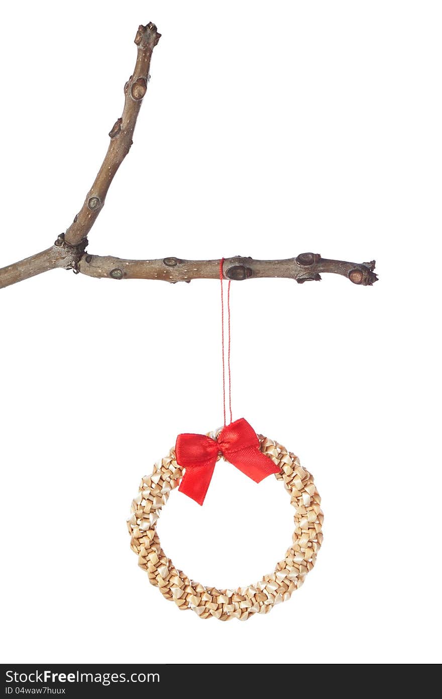 Decorative straw wreath on a branch for Christmas. Isolated. Decorative straw wreath on a branch for Christmas. Isolated.