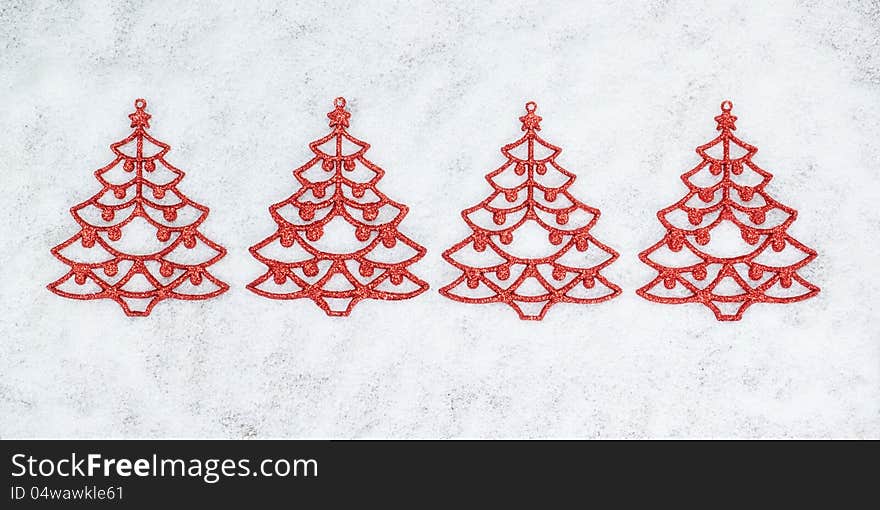 Four decorative Christmas tree closeup on the snow. Four decorative Christmas tree closeup on the snow.