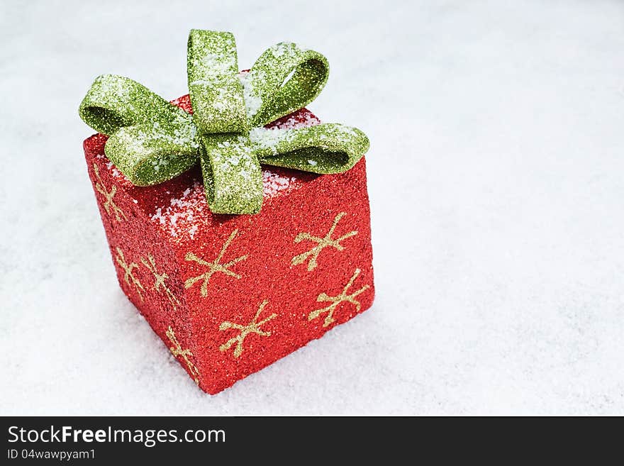 Christmas gift box with a bow on snow. Christmas gift box with a bow on snow.