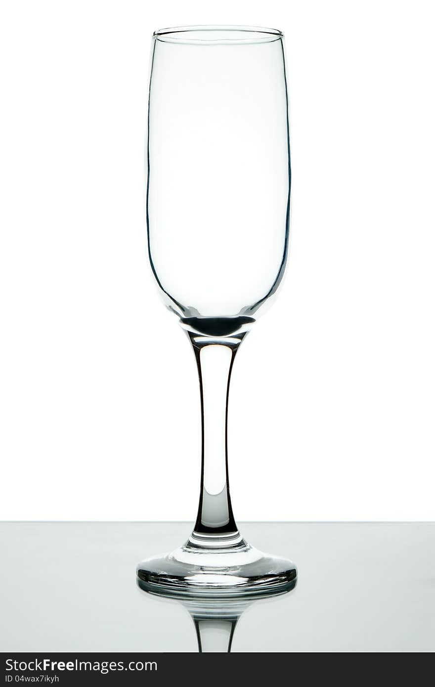 Empty wine glass on a leg on a white background. Empty wine glass on a leg on a white background.