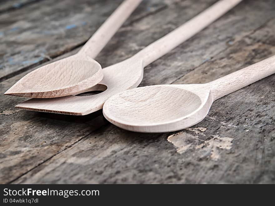 Wooden spoons on old retro wooden background