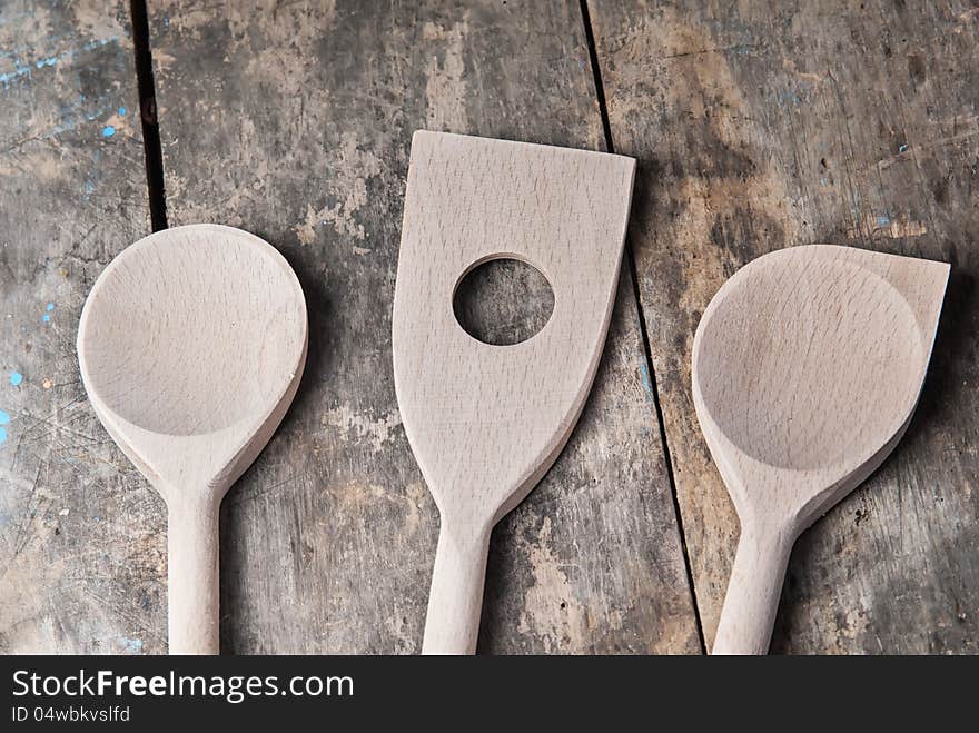 Wooden spoons on old retro wooden background