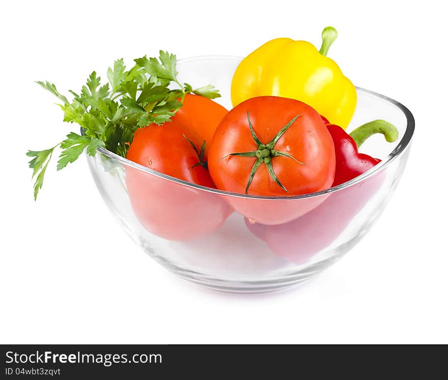 Fresh colorful vegetables in a oval glass bowl  on white. Fresh colorful vegetables in a oval glass bowl  on white