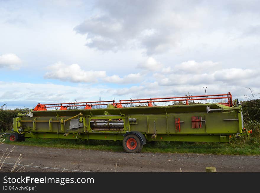 Head off a combine harvester parked in farm lane. Head off a combine harvester parked in farm lane