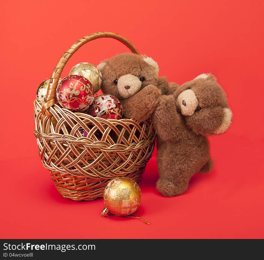 Teddy Bears and a basket with Christmas toys.