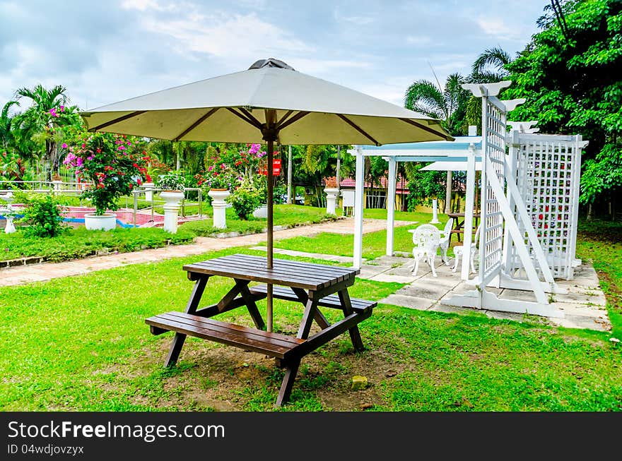 White cottage resting place with flower at white wall garden. White cottage resting place with flower at white wall garden