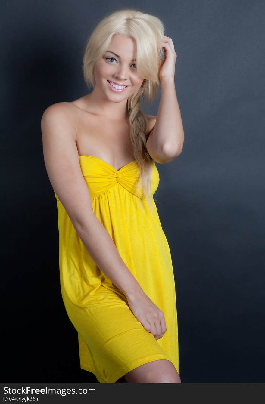 An image of a beautiful woman in a yellow dress. An image of a beautiful woman in a yellow dress