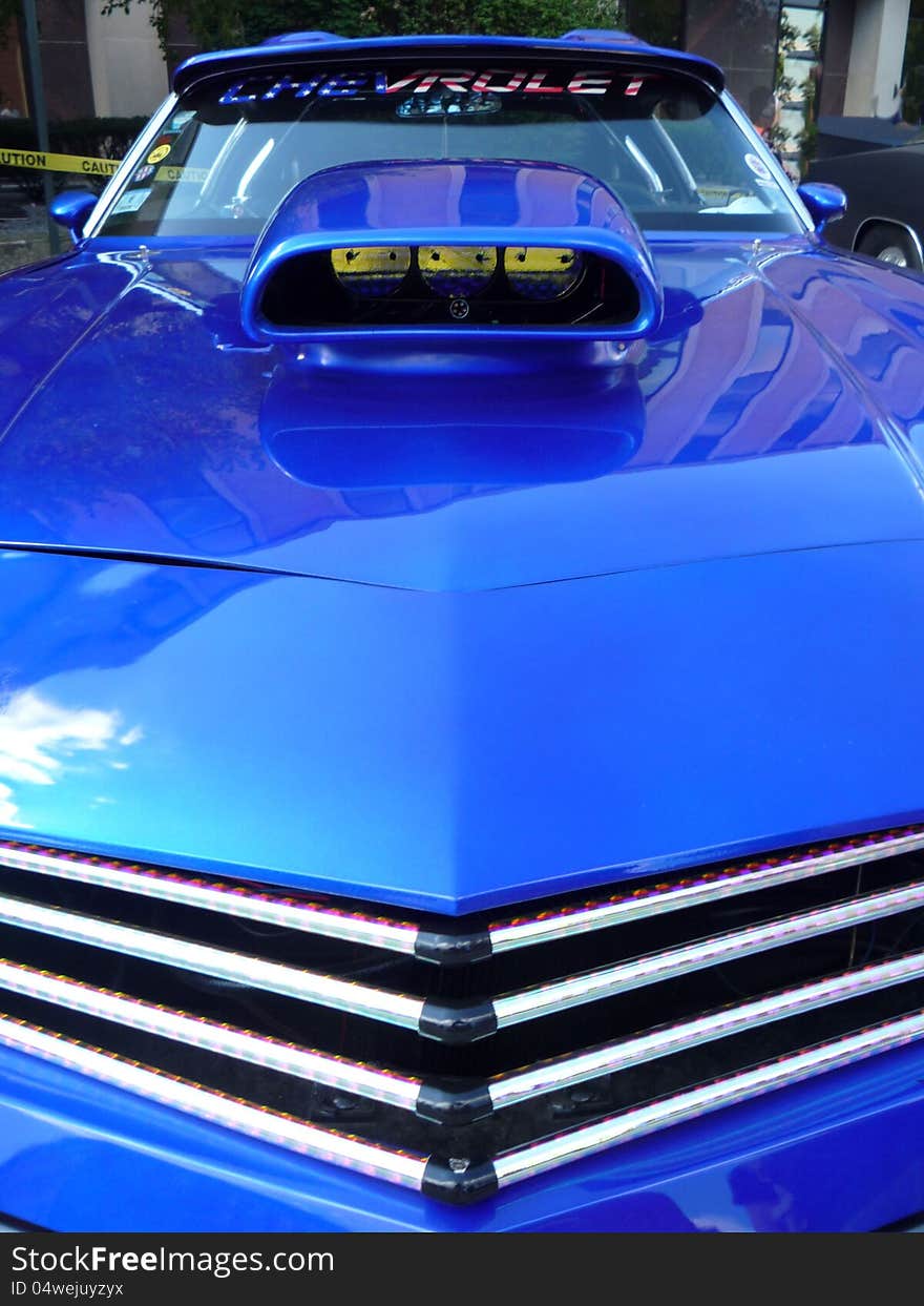 Front grill view of a blue car with air scoop. Front grill view of a blue car with air scoop