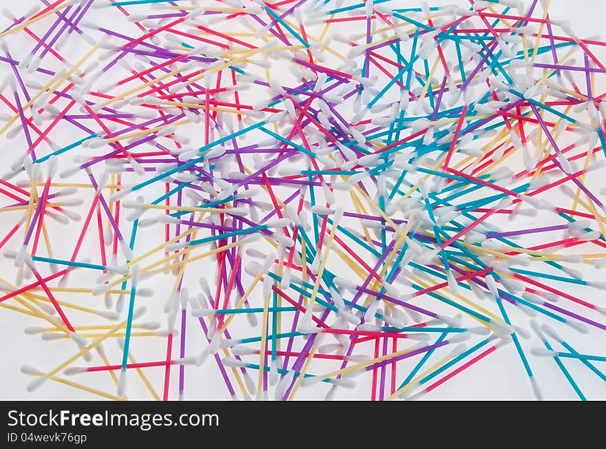 Mixed colors of q-tips on white table. Mixed colors of q-tips on white table