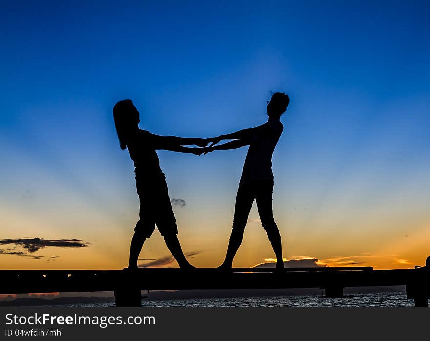 Girls standing on Bridge at Sunrise