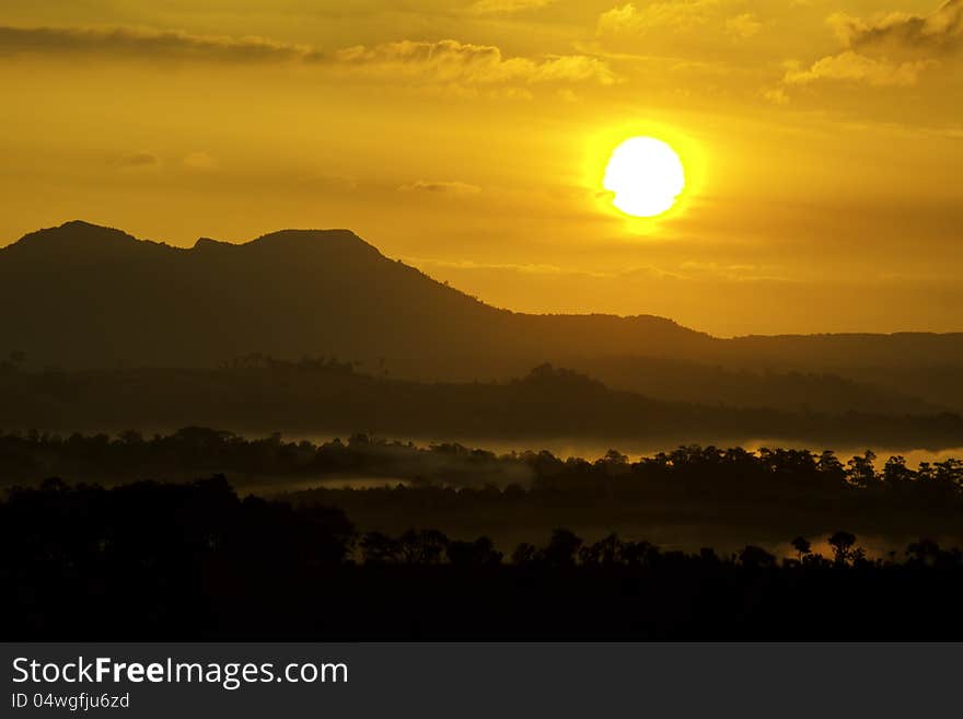 Sunset beyond the lake and hill in the forest. Sunset beyond the lake and hill in the forest.