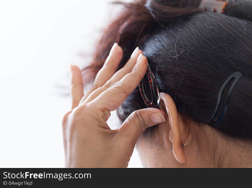 Self making of hairstyle using clip by indian girl isolated over white. Self making of hairstyle using clip by indian girl isolated over white