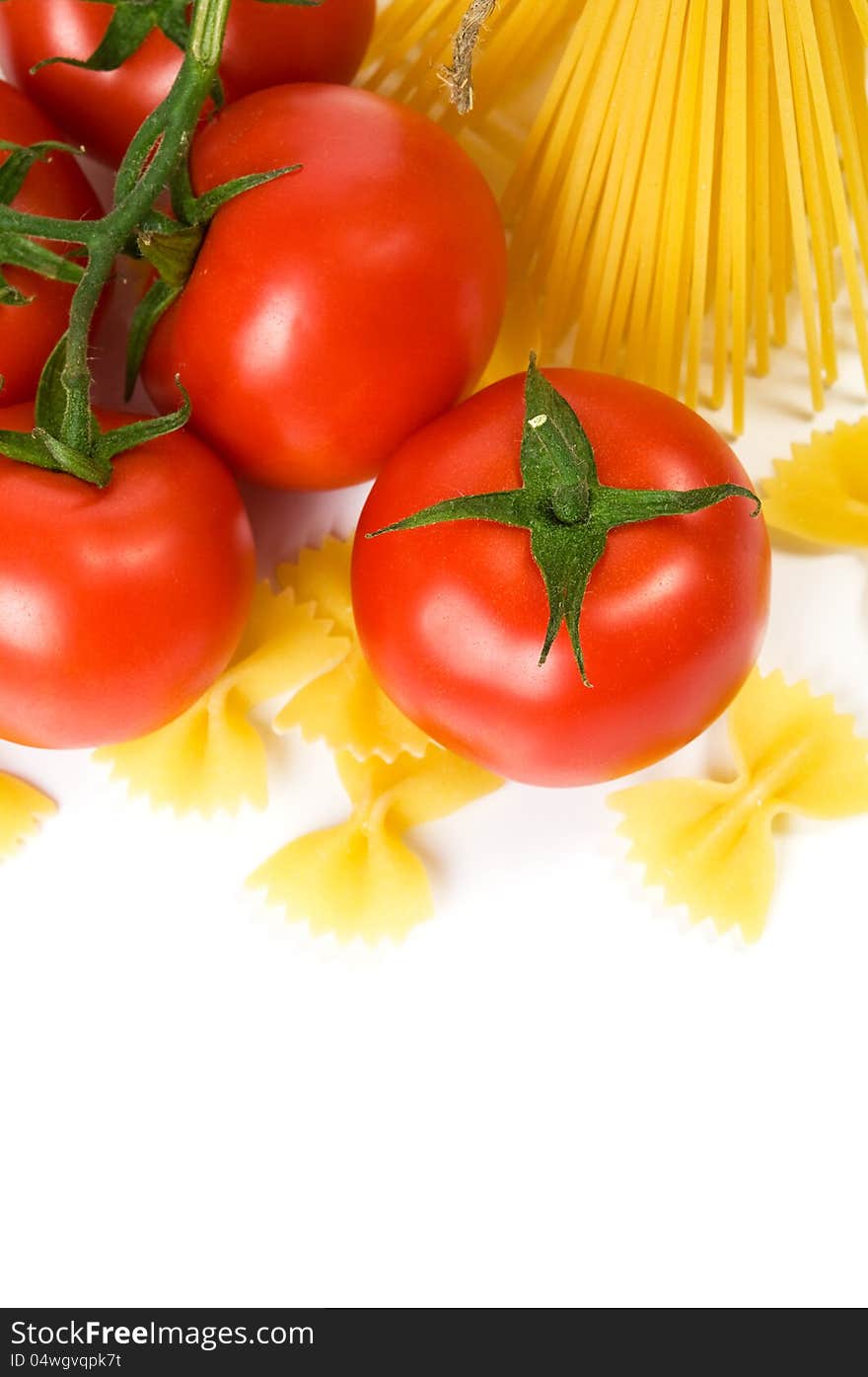 Pasta and tomatoes on the white with copy space