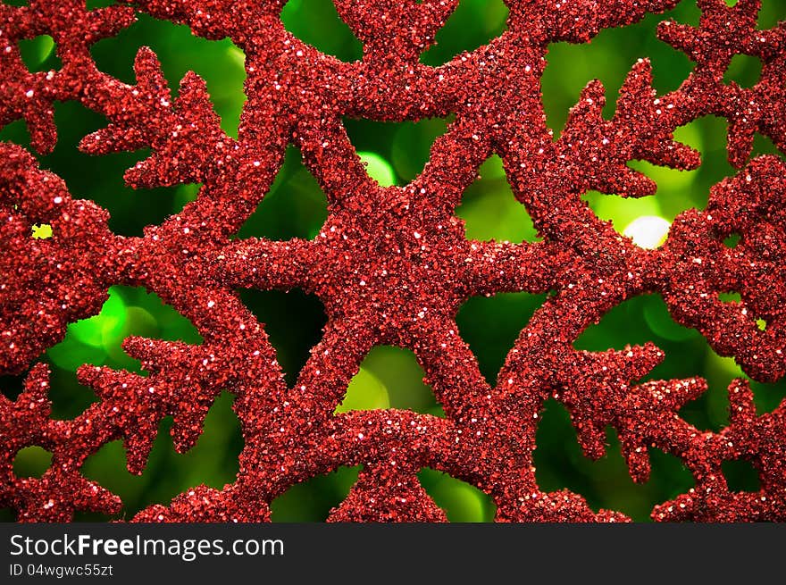 Red Snowflake On Green Blurred Background