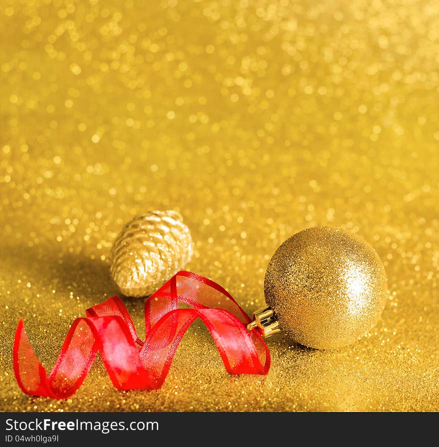 Christmas ornaments on background of defocused golden lights with bokeh effect and copy space. Christmas ornaments on background of defocused golden lights with bokeh effect and copy space