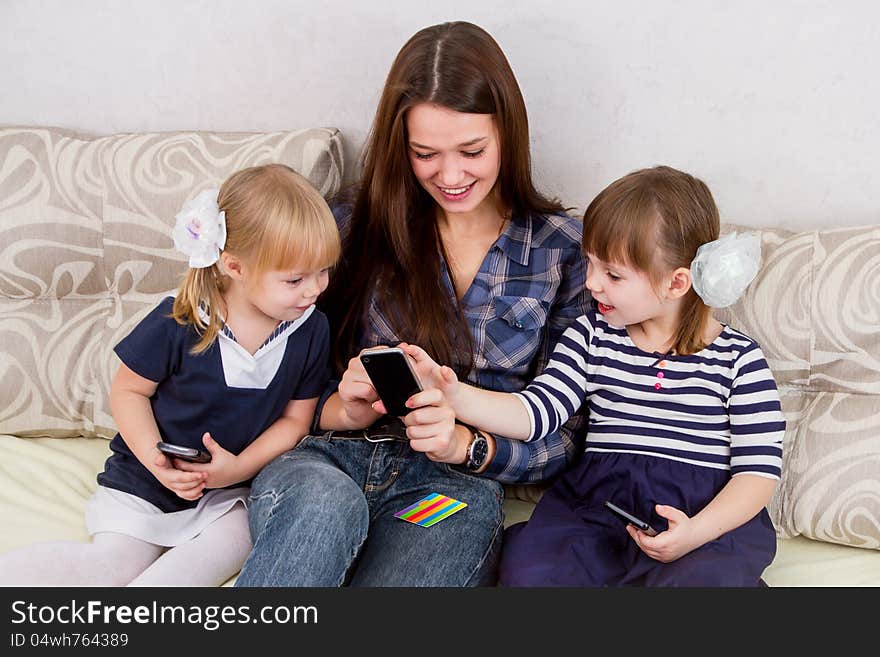 Three sisters with smartphones