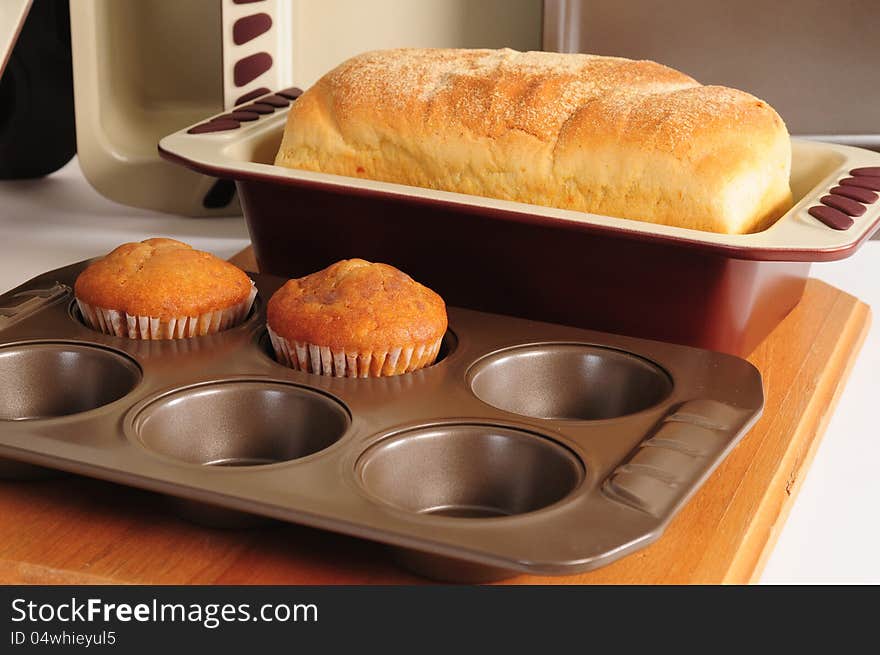 Baked bread and muffins on kitchen counter. Baked bread and muffins on kitchen counter.