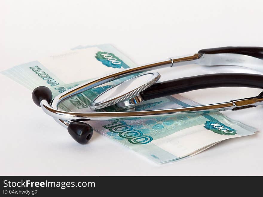 Stethoscope and banknotes on a white background close-up