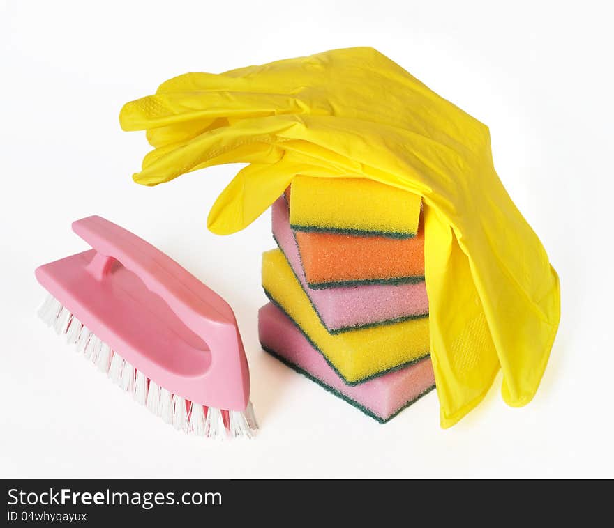 Different colors sponges for washing dishes, brush and rubber gloves on a white background. Different colors sponges for washing dishes, brush and rubber gloves on a white background