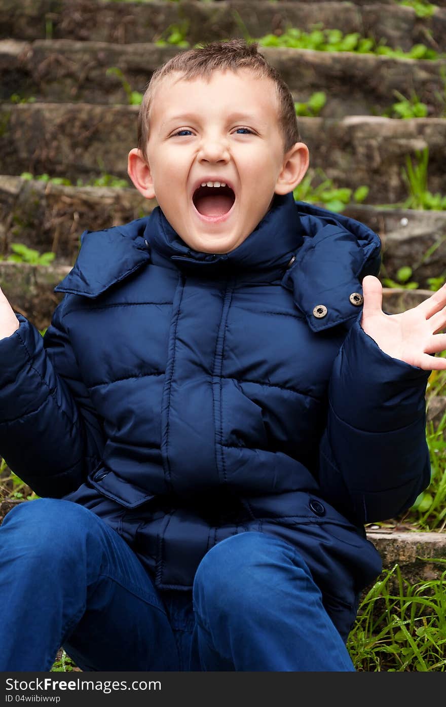 Little cute boy screaming outdoors