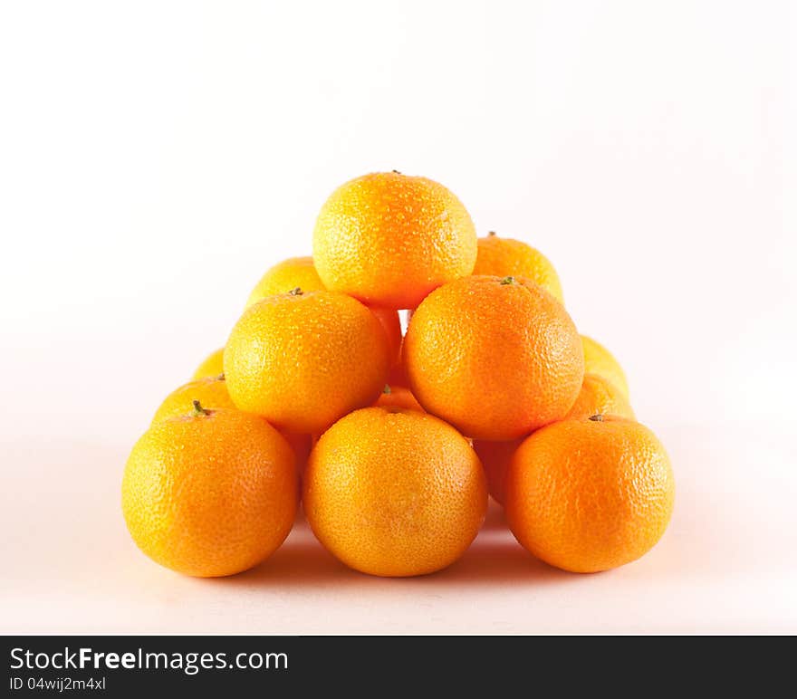 Pyramide of fresh mandarins on a white background