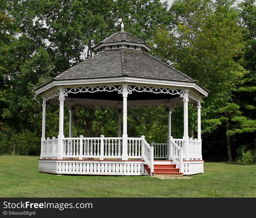 White Wooden Gazebo Bandstand In Park.