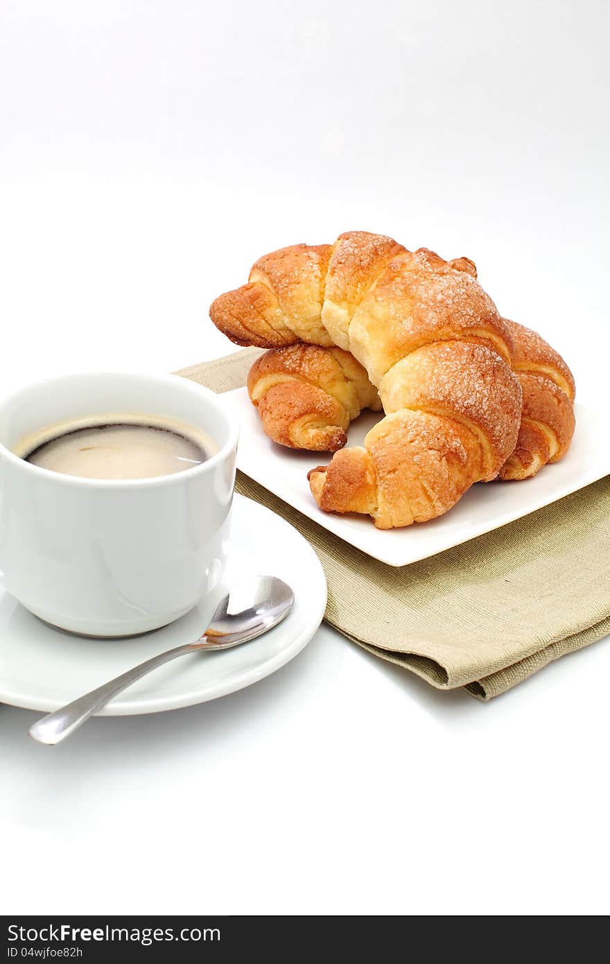 Croissants ans a cup of coffee  in white background