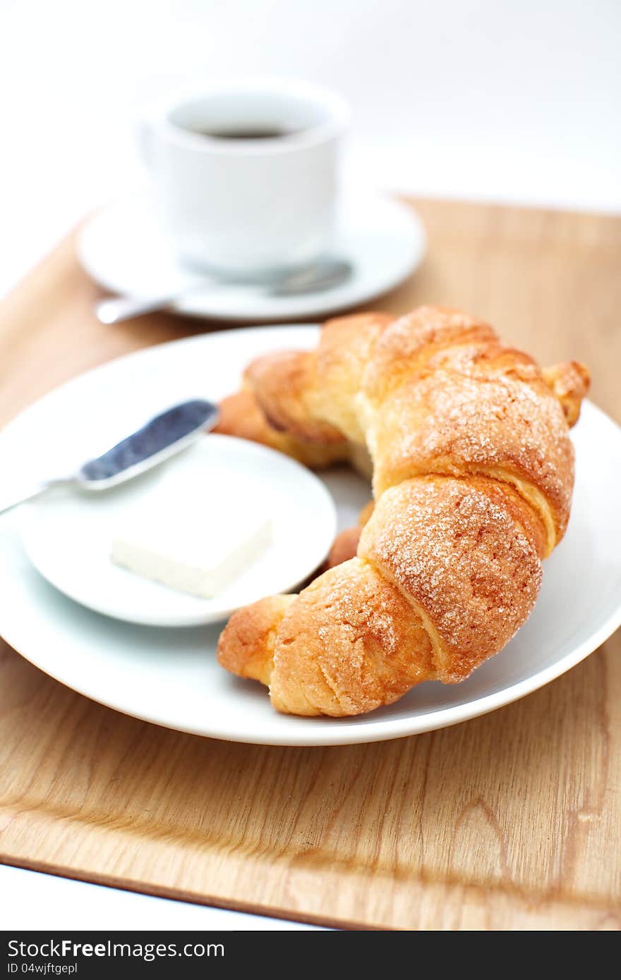 Croissants ans a cup of coffee in white background