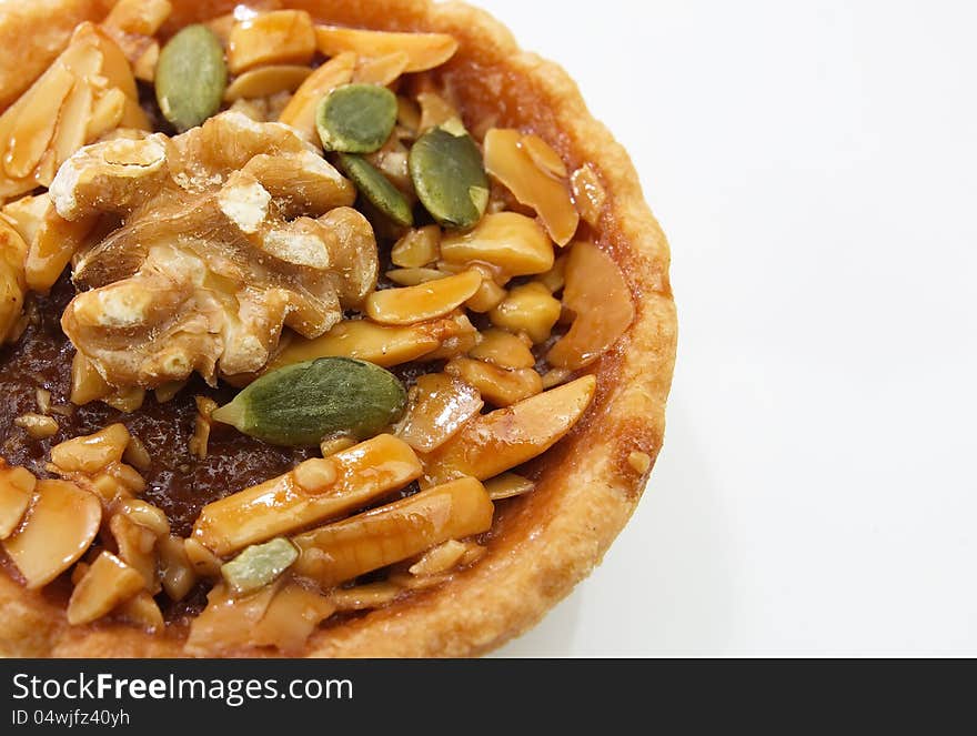 Closeup to cup cake , caramel nuts tart on white background