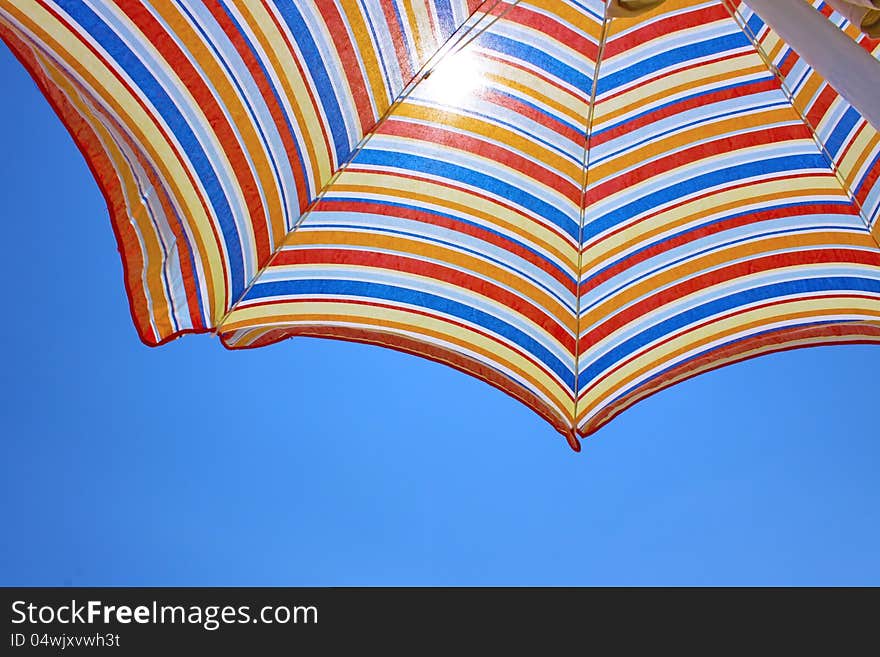 Blue sky and beach umbrella