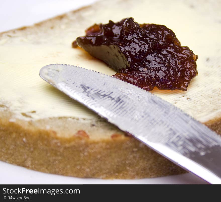 Closeup of bread with butter and strawberry jam. Closeup of bread with butter and strawberry jam