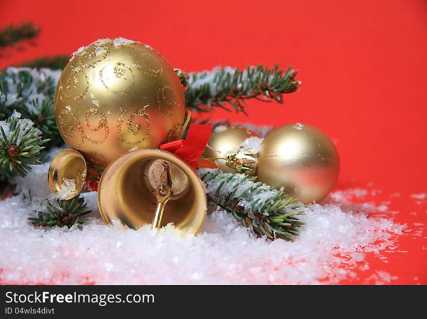 Gold christmas bells and balls on snow. Gold christmas bells and balls on snow