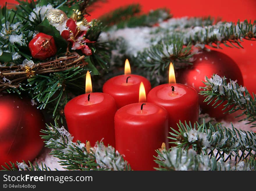 Four red advent candles with fir twigs and ornaments. Four red advent candles with fir twigs and ornaments