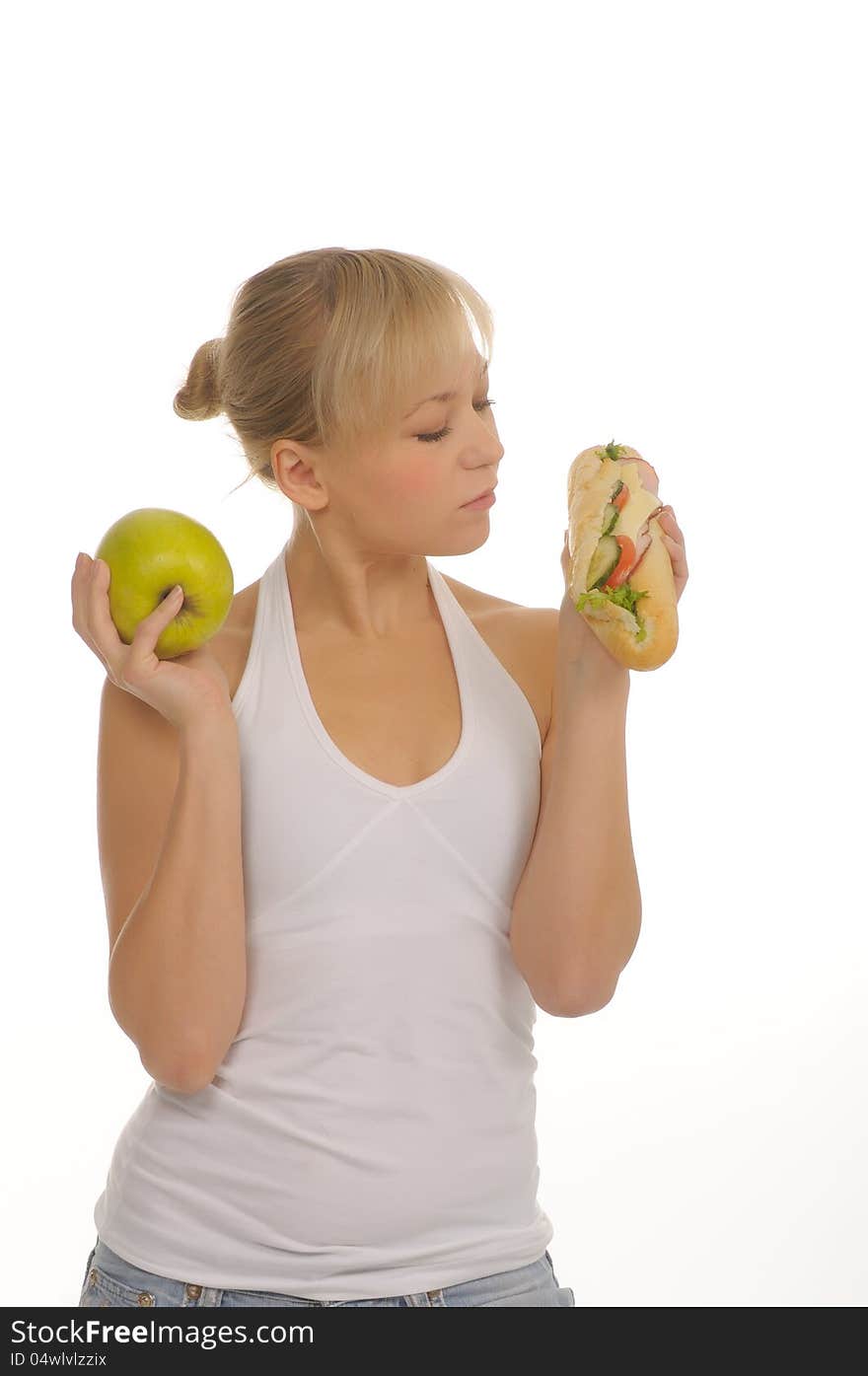 Slim woman choosing between apple and hamburger