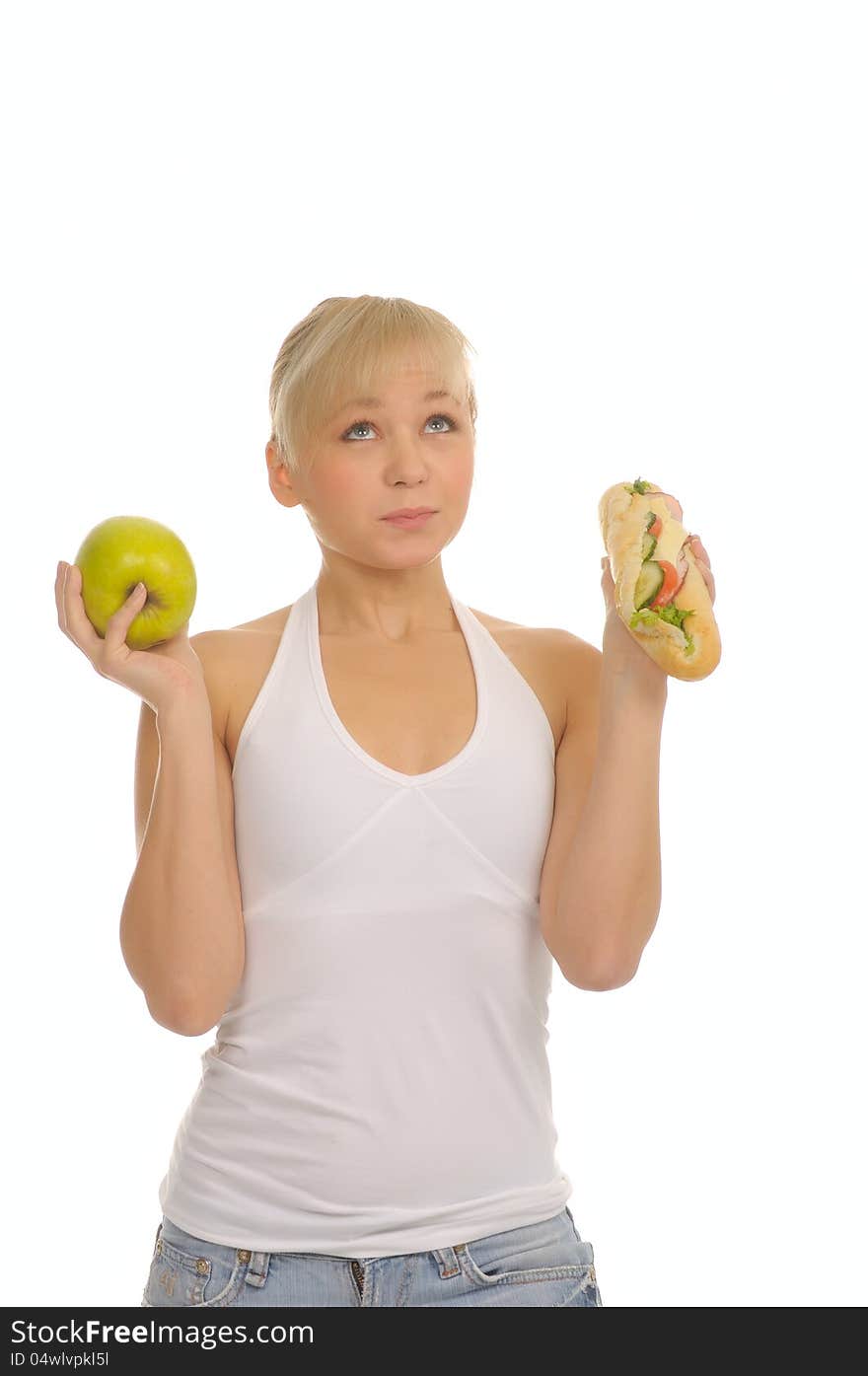 Slim woman choosing between apple and hamburger